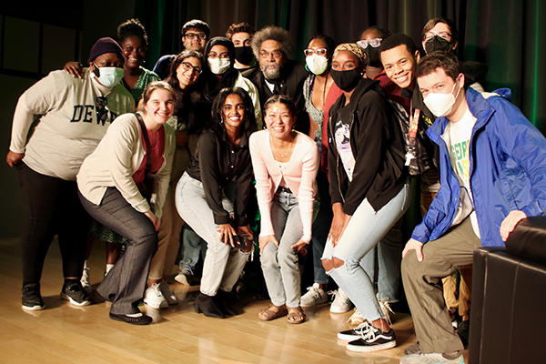 Photo of Cornel West, center, posing with students following his conversation with Schar School Associate Professor Michael K. Fauntroy