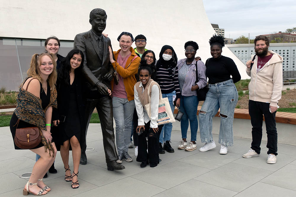IR Task Force students posing with a statue of John F. Kennedy at the Kennedy Center.