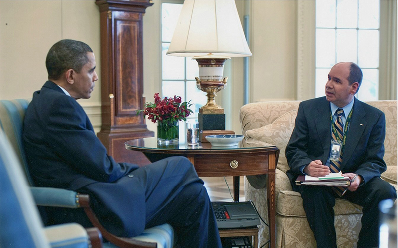 James P. Danoy with a folder on his lap sits across from President Obama in the Oval Office.