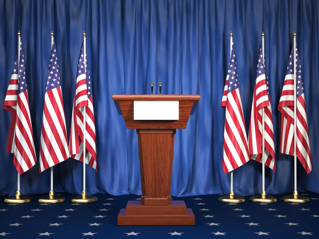 Photo of a podium with American flags next to it