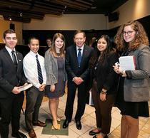 David Petraeus former CIA director stands with Schar School undergraduate students