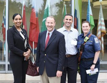 Class of 2024 cohort members pose with their professor: From left, Marwa Hajahmed, probation officer and mediator for Fairfax County’s Juvenile and Domestic Relations Court; Burroughs; Yousri Ben Slimane, code enforcement supervisor for Arlington County; and Jennifer Poppino, Fairfax County Fire and Rescue battalion chief.